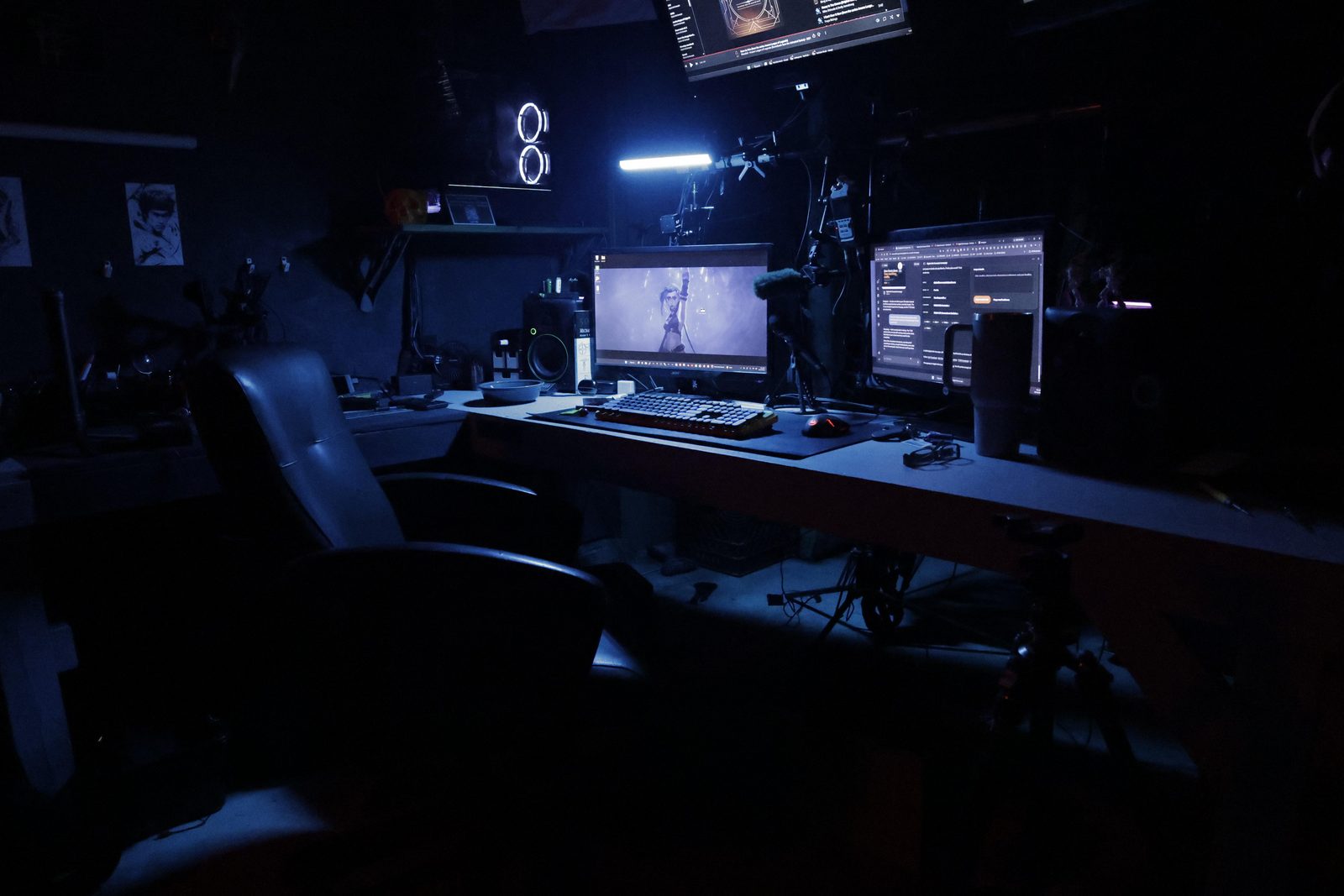 Close view of the TacticalTech3D design desk with backlit keyboard and monitors showing work in progress.